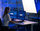 TDK-Lambda – Bild – Making Of – Mitarbeiterin sitz vor PC und wird von großer Softbox angeleuchtet
